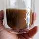 hand holding mug of maxim coffee